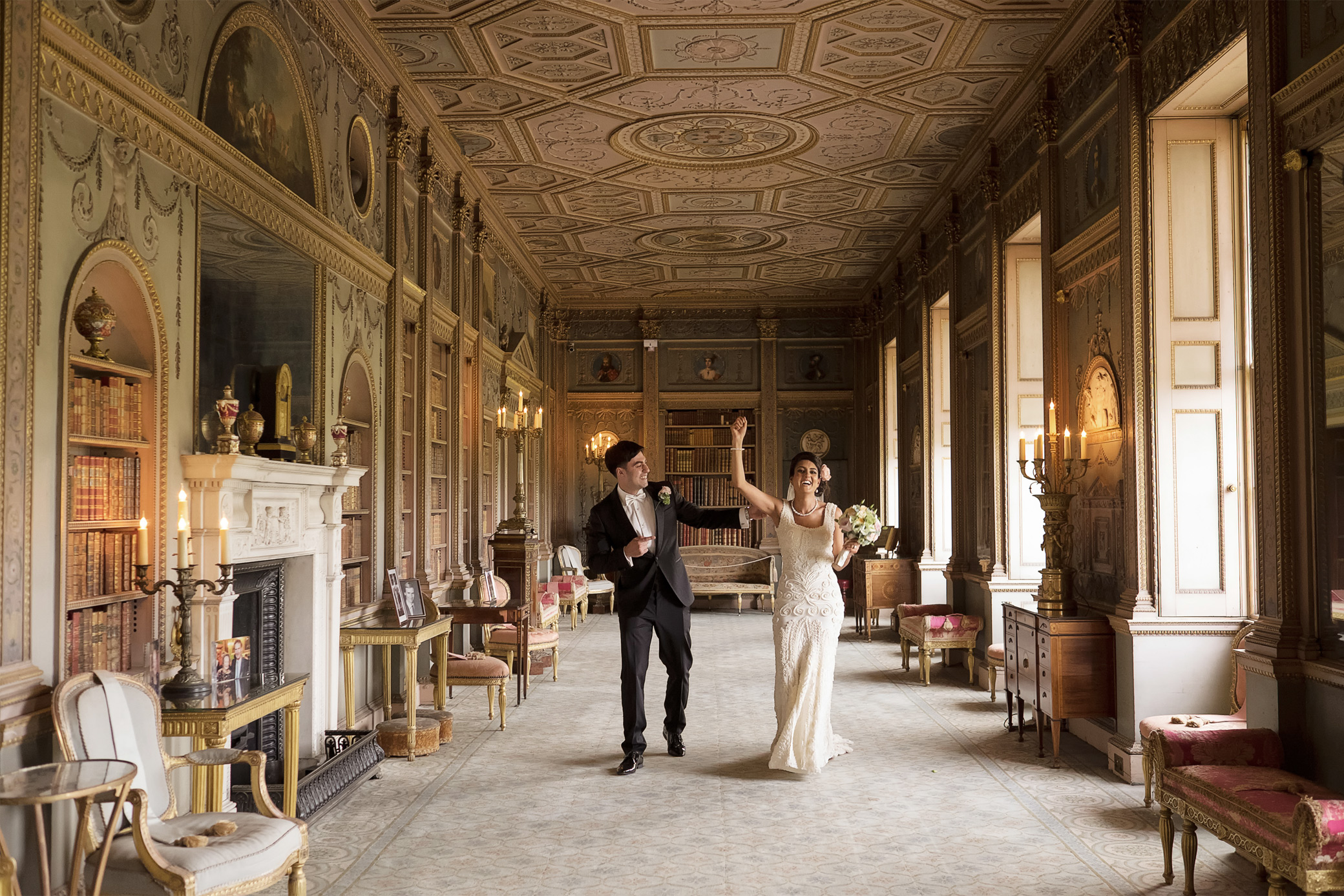 Bride and groom walking through the Long Gallery at Syon House