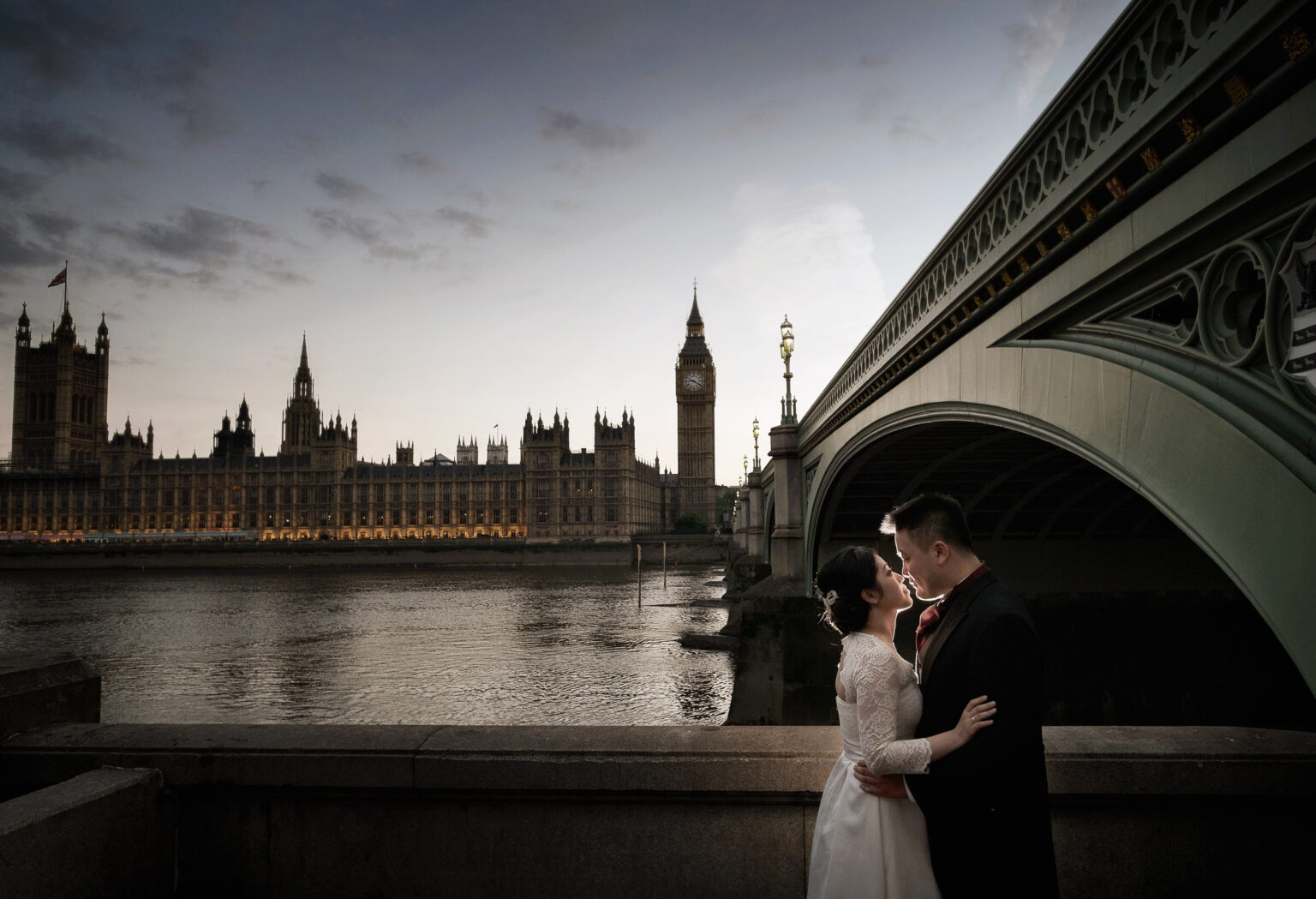 Pre wedding couple under Westminster Bridge with the Houses of Parliament and Big Ben behind