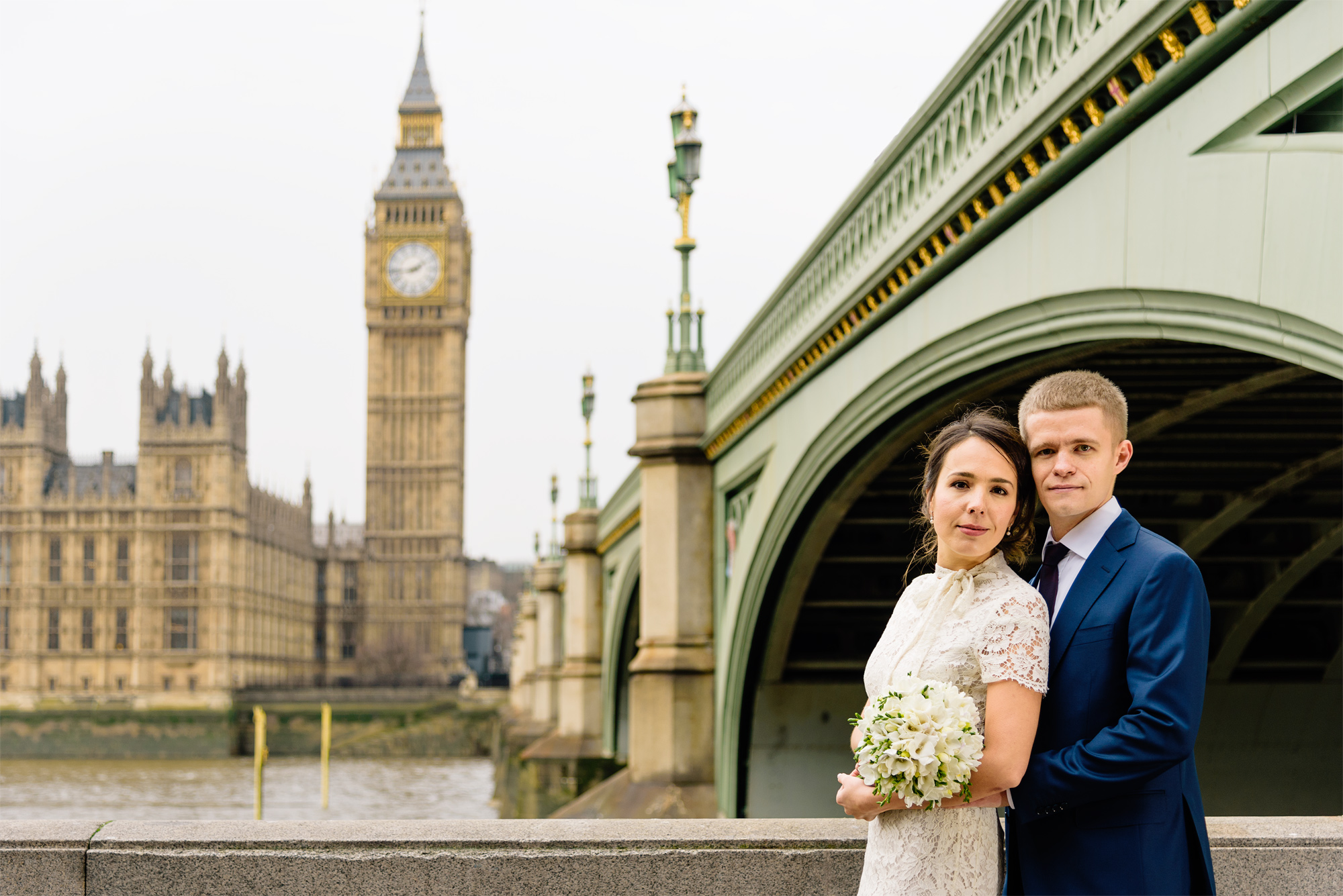 Bride and groom by Westminster Bridge with the Houses of Parliament behind