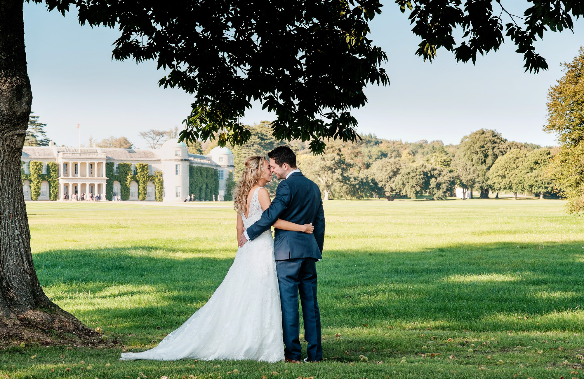 bride-and-groom-in-front-of-goodwood-house-summer-wedding