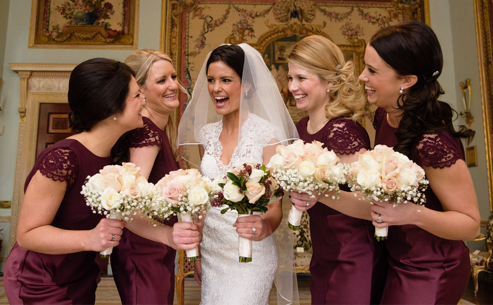bride-and-bridesmaids-laughing-at-wedding