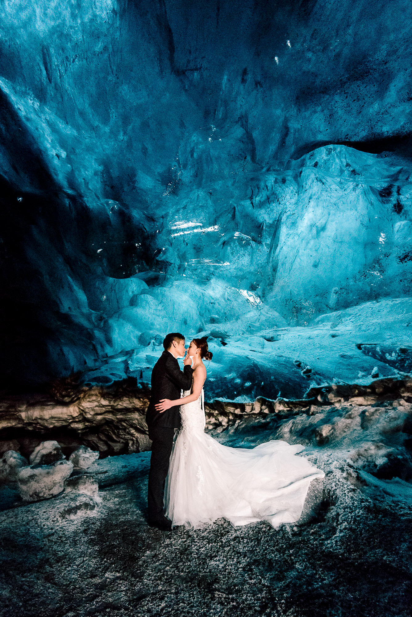 Couple inside a blue glacier ice cave in Iceland