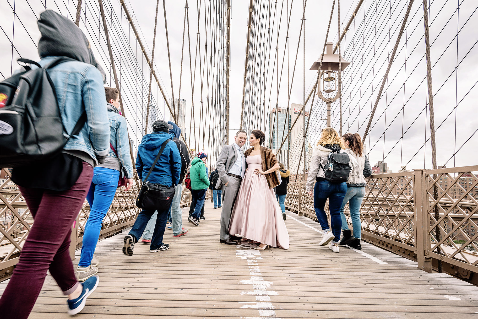 Couple on the Brooklyn Bridge walkway during a pre-wedding shoot in New York