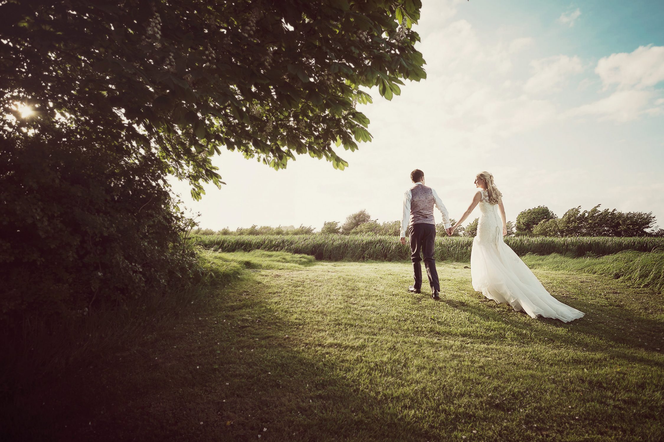 Summer wedding photography bride and groom sunset in field