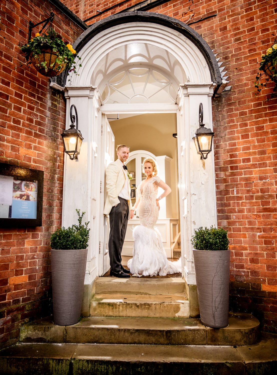 Bride and groom in the doorway of Chichester Harbour Hotel