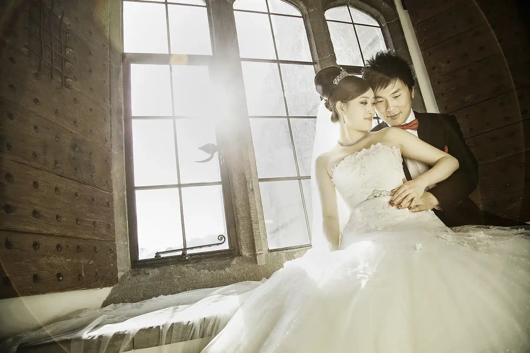 bride and groom backlit by window Leeds castle wedding