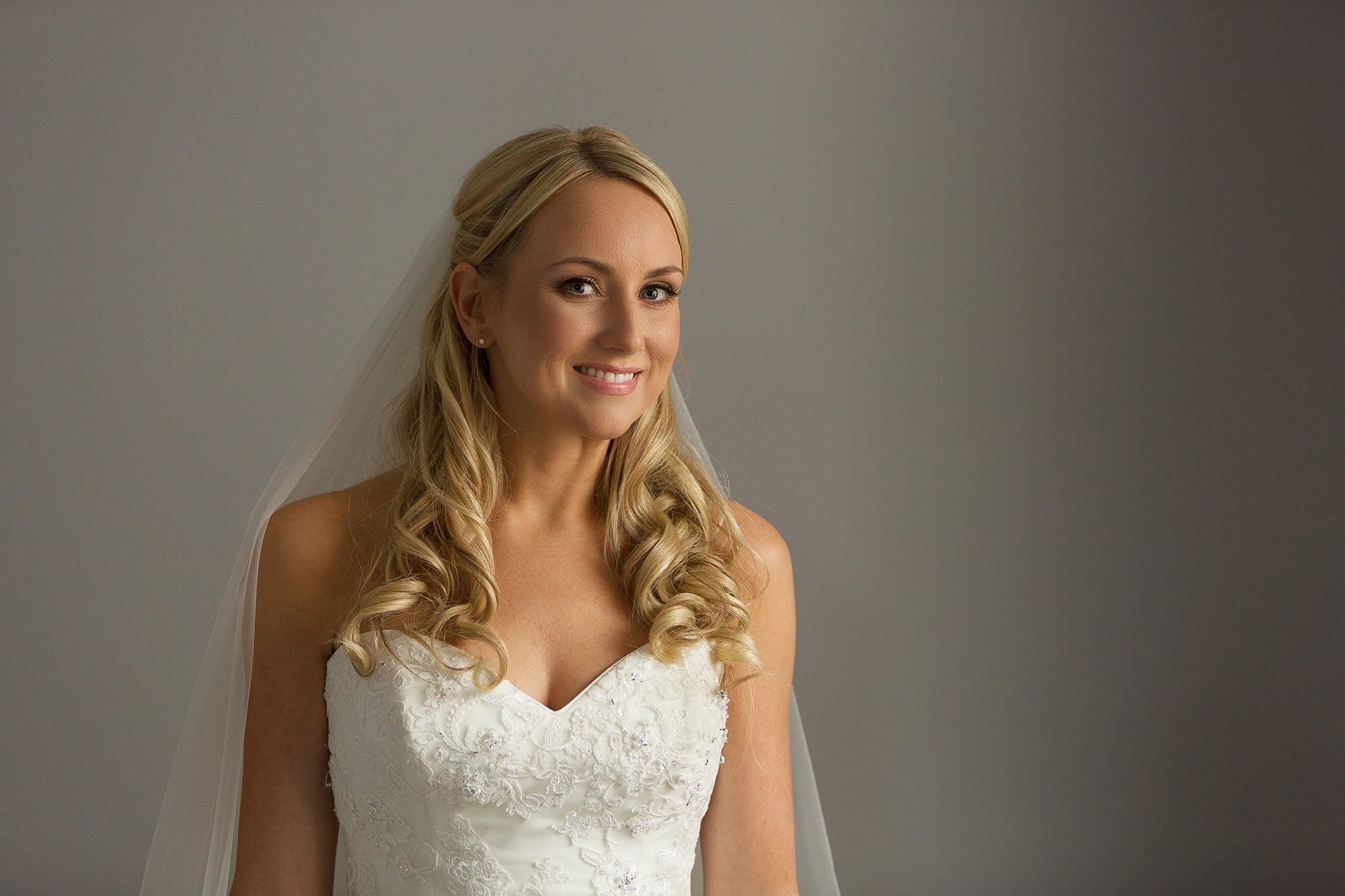 Bridal portrait in window light at a Sussex wedding, photographed by Barrie Downie