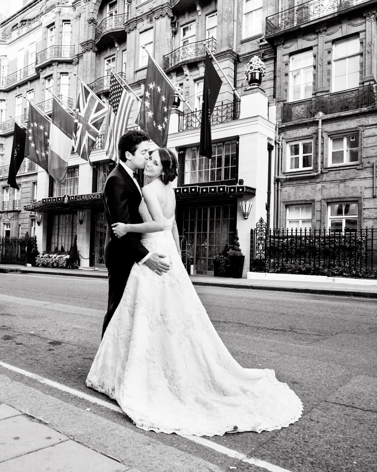 Bride and groom on a Mayfair street after their wedding at Claridge’s, black and white