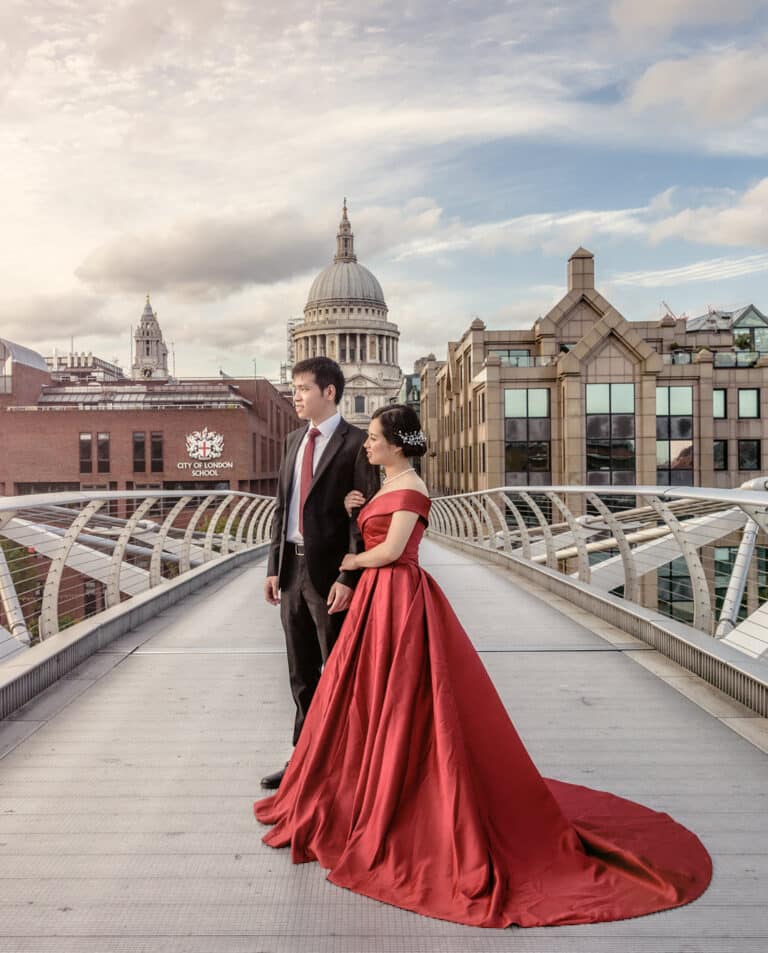 Couple in a red gown on the Millennium Bridge with St Paul's Cathedral behind