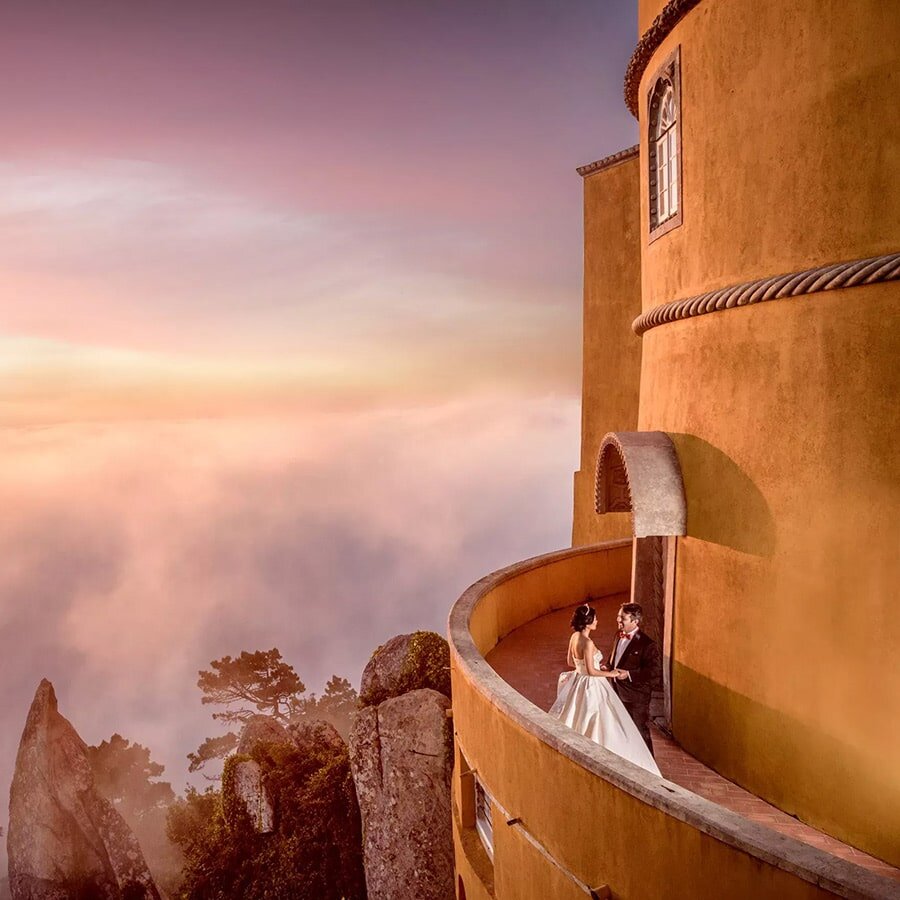 Bride and groom on the terrace of Pena Palace at sunset, Sintra, Portugal destination wedding