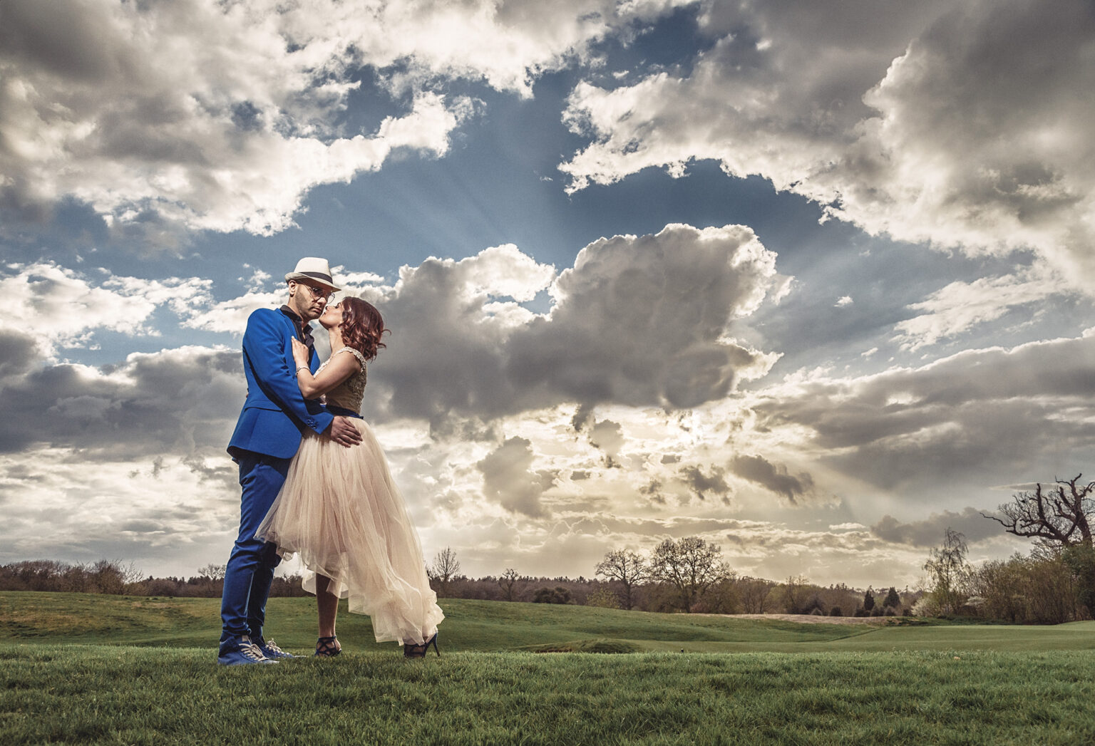 Bride and groom under a dramatic sky at The Grove