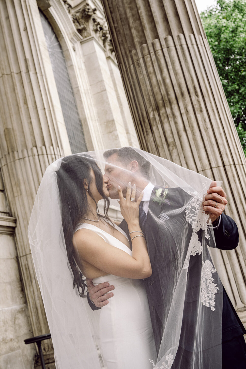 Couple kissing beneath the columns of St Paul's Cathedral