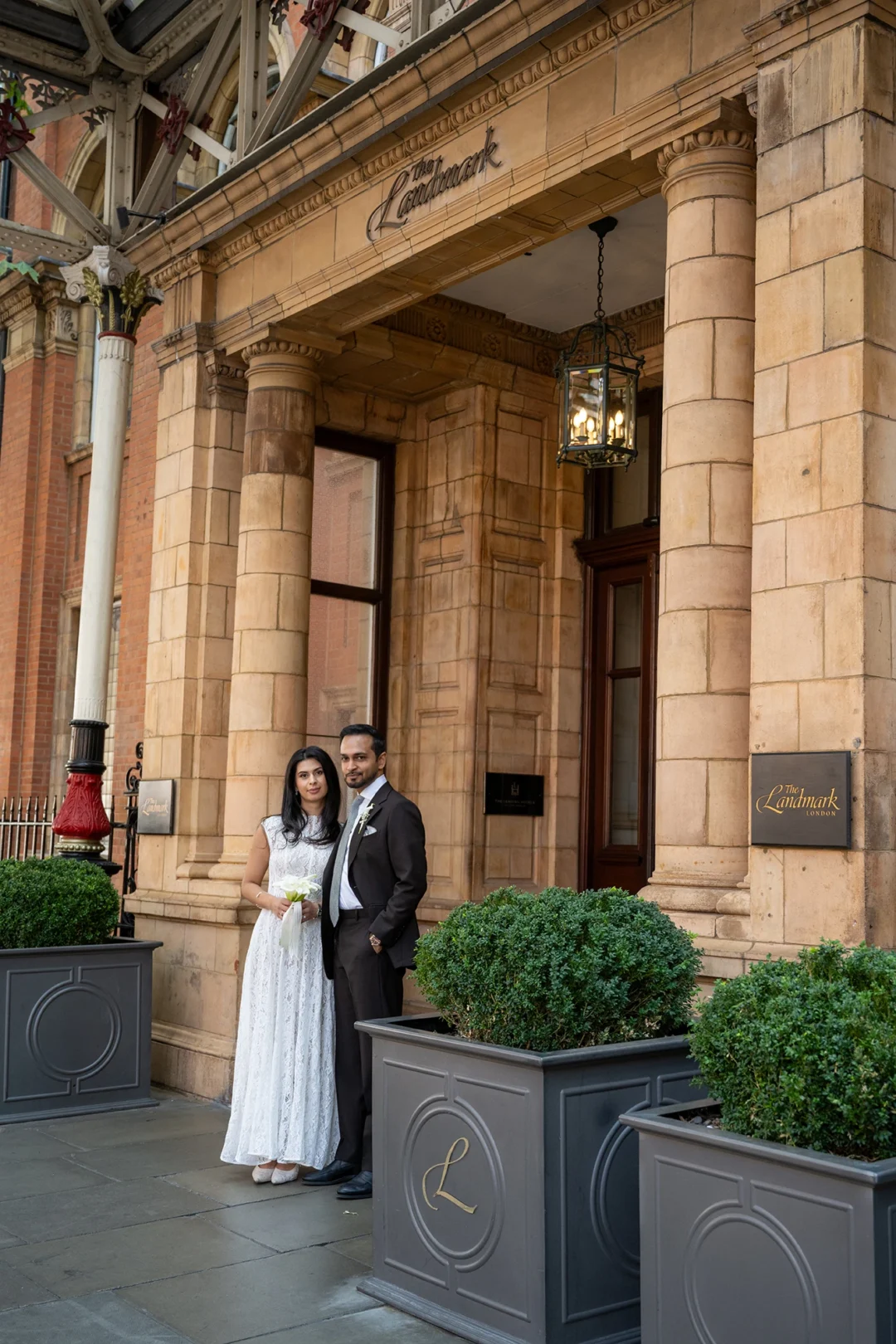 Bride and groom outside the entrance to The Landmark London, a five-minute walk from Old Marylebone Town Hall