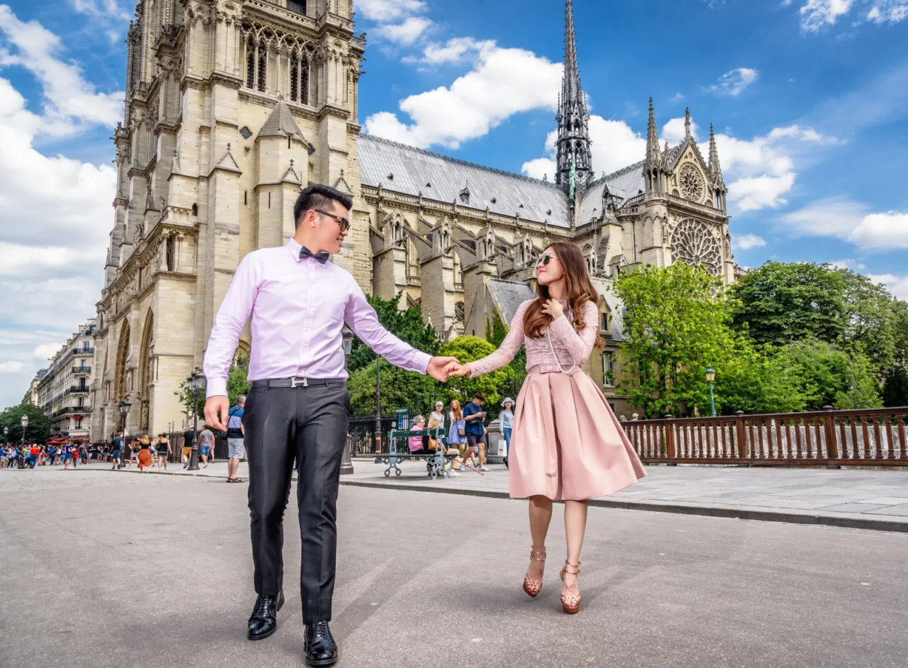 Couple walking hand in hand in front of Notre-Dame, Paris pre wedding shoot