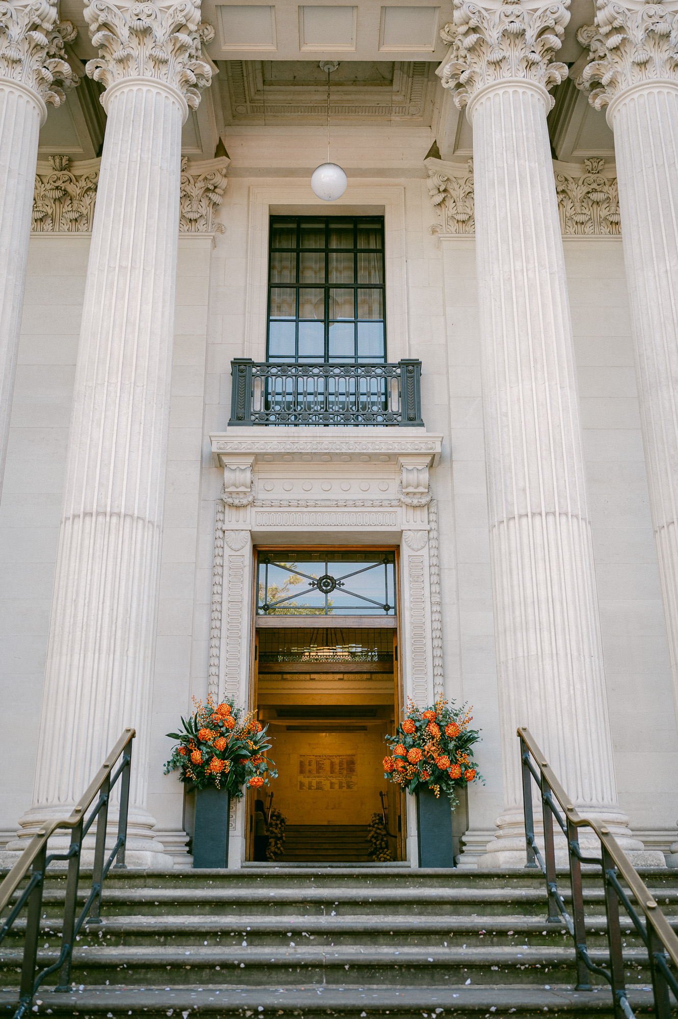The entrance to Old Marylebone Town Hall with autumn flowers by the doors