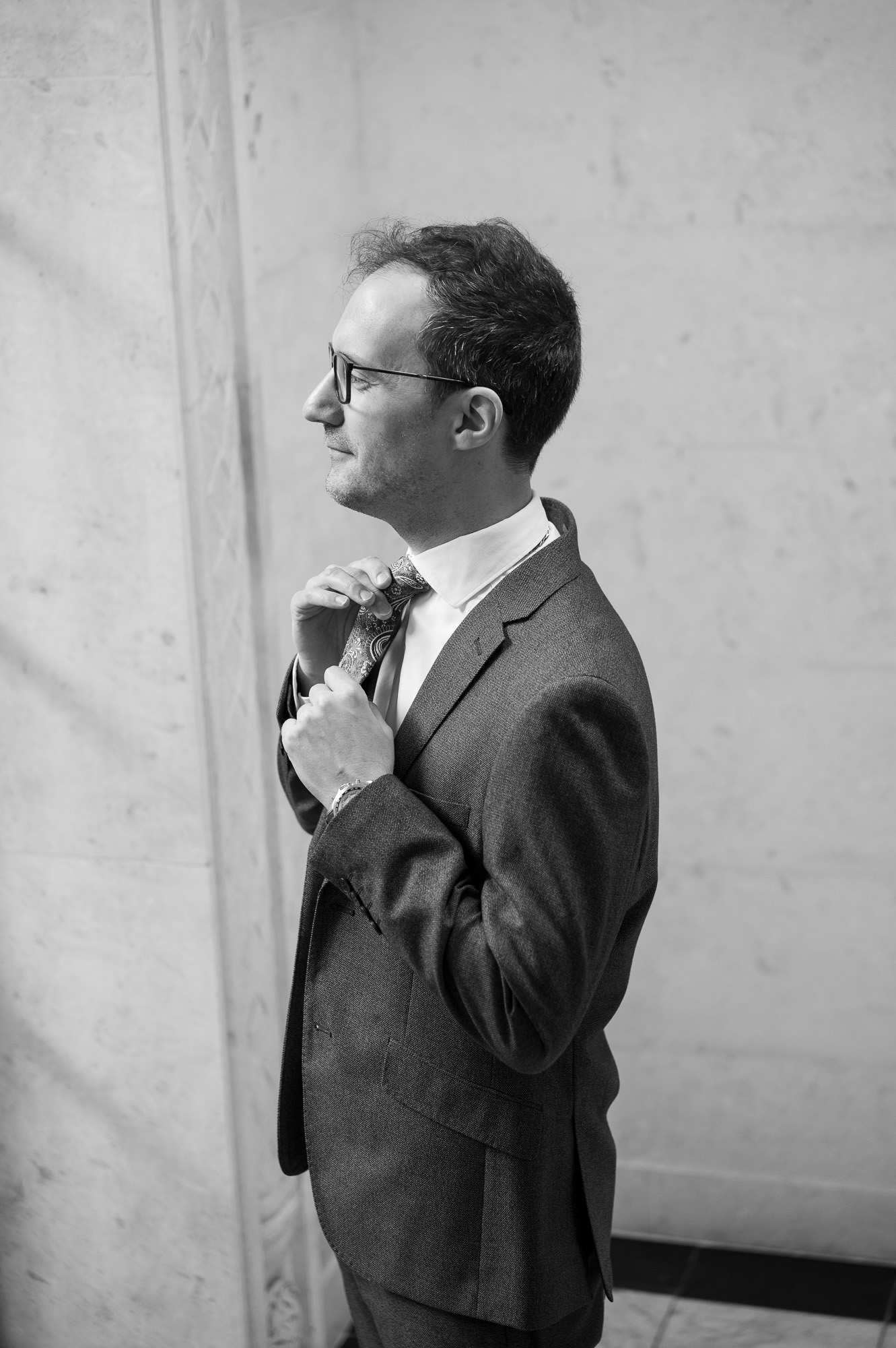 Groom straightening his tie before his Old Marylebone Town Hall wedding