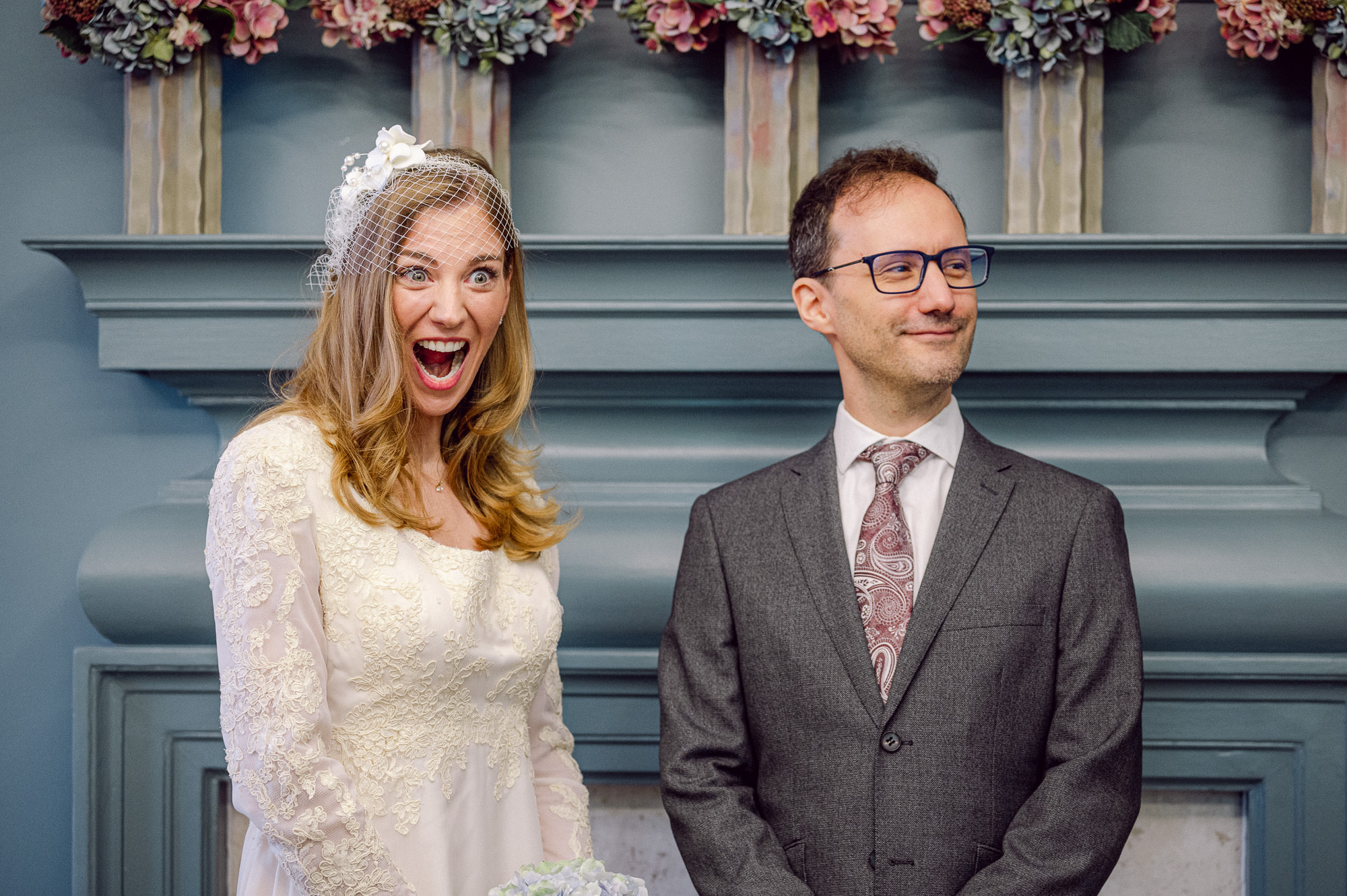 Bride and groom laughing during their ceremony in the Knightsbridge Room