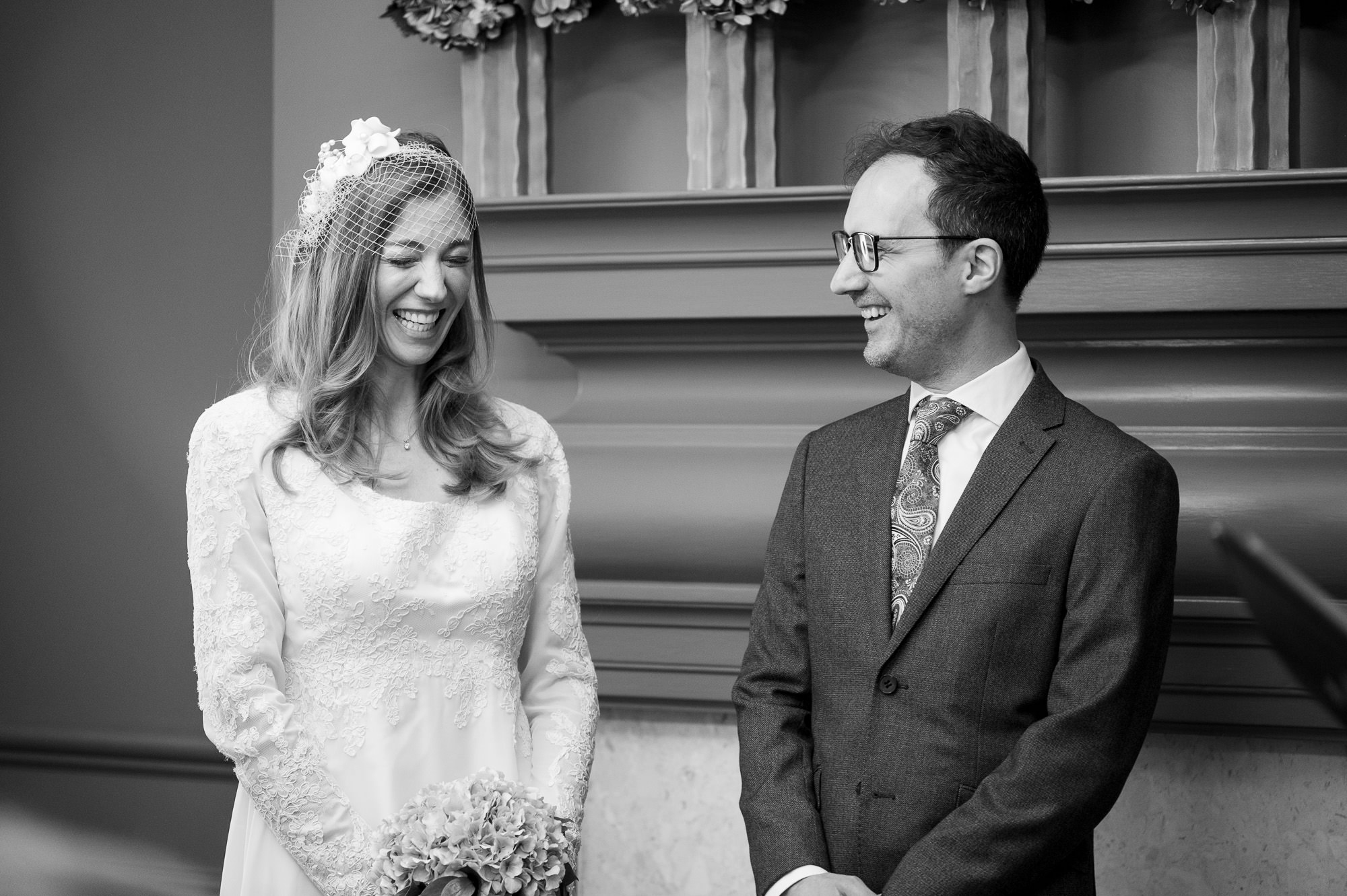 Bride and groom smiling at each other during the ceremony