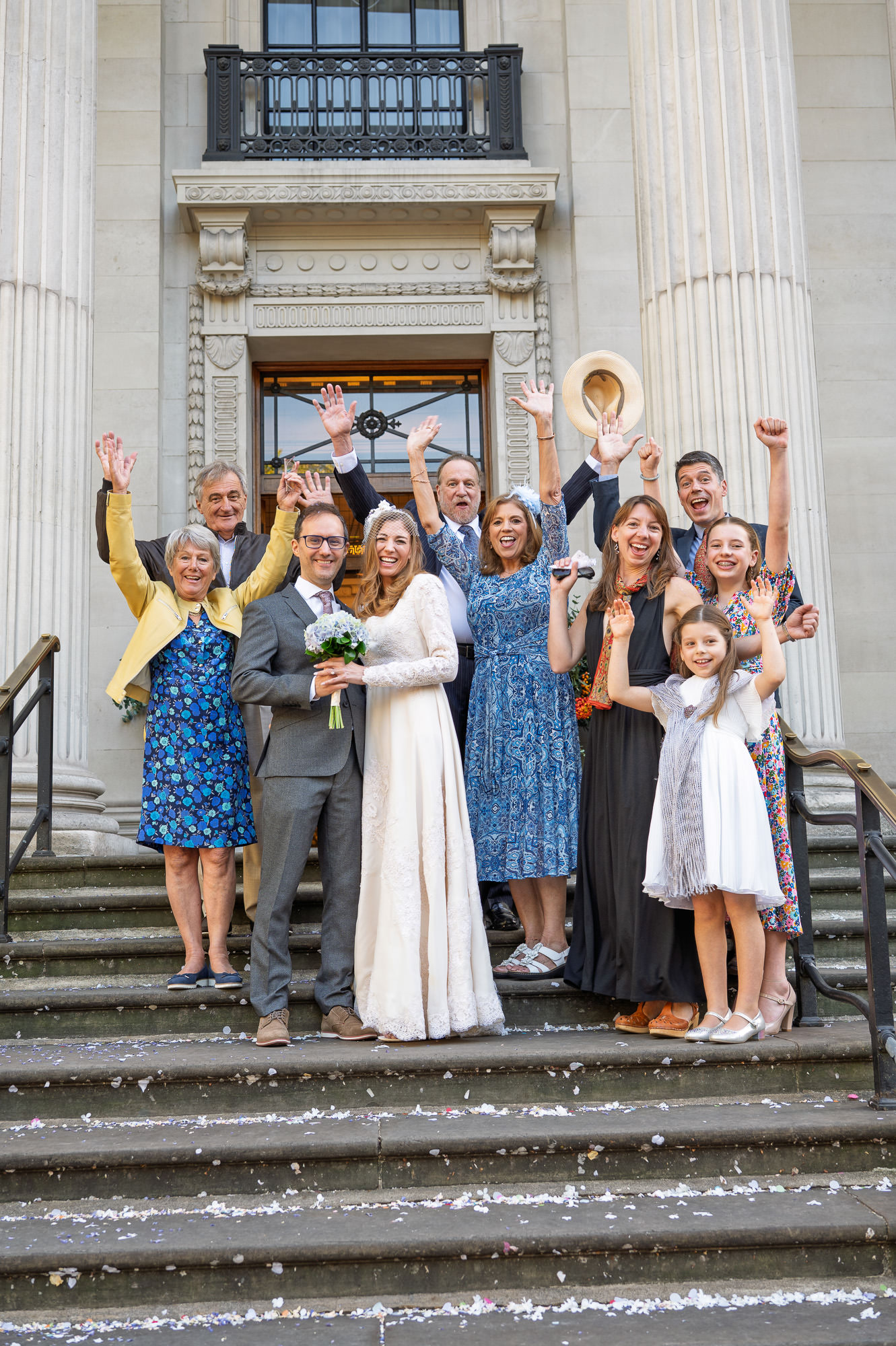 Family group cheering on the steps of Old Marylebone Town Hall