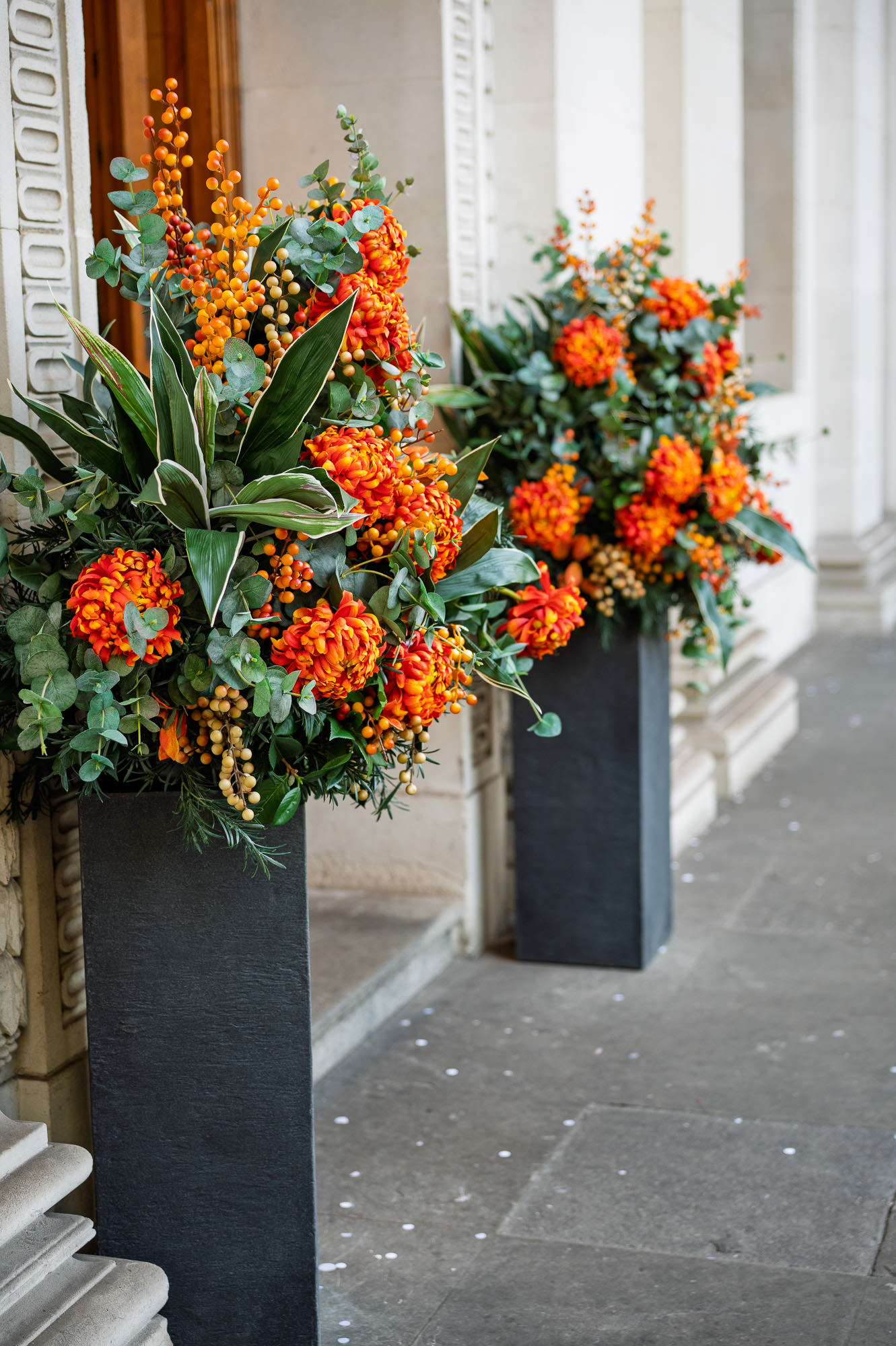 Orange and red flower arrangements at the entrance of Old Marylebone Town Hall