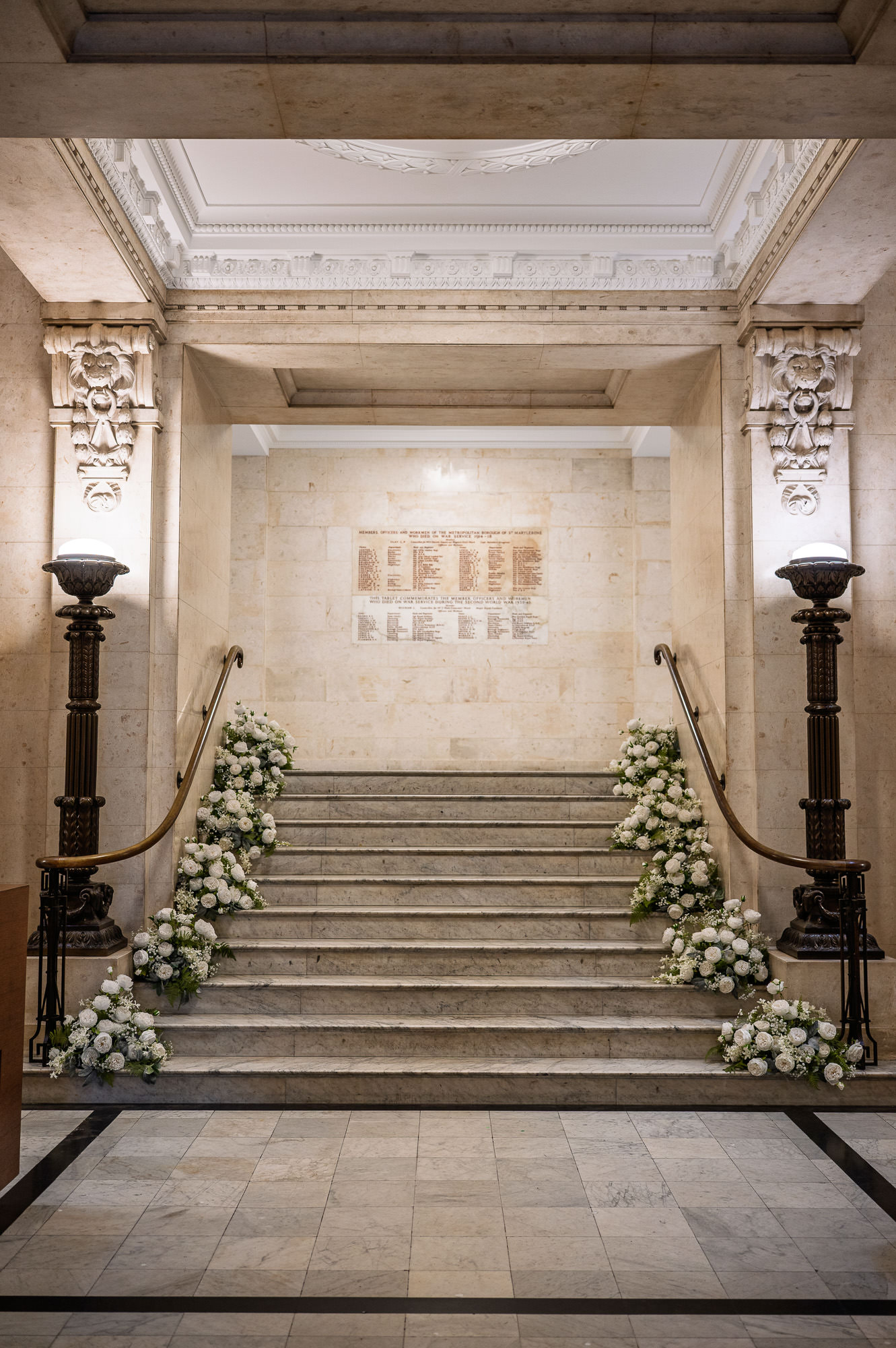 The marble staircase at Old Marylebone Town Hall dressed with white flowers