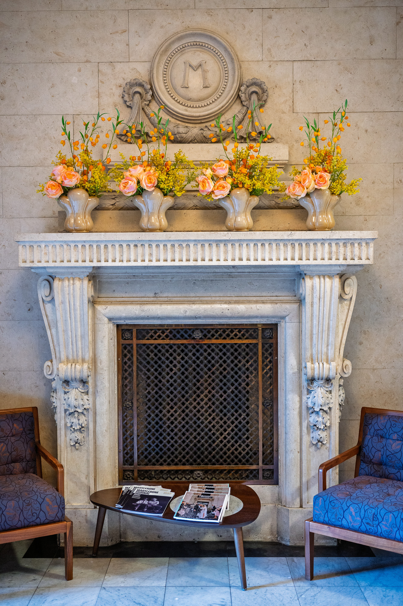 Carved fireplace with orange flowers inside Old Marylebone Town Hall