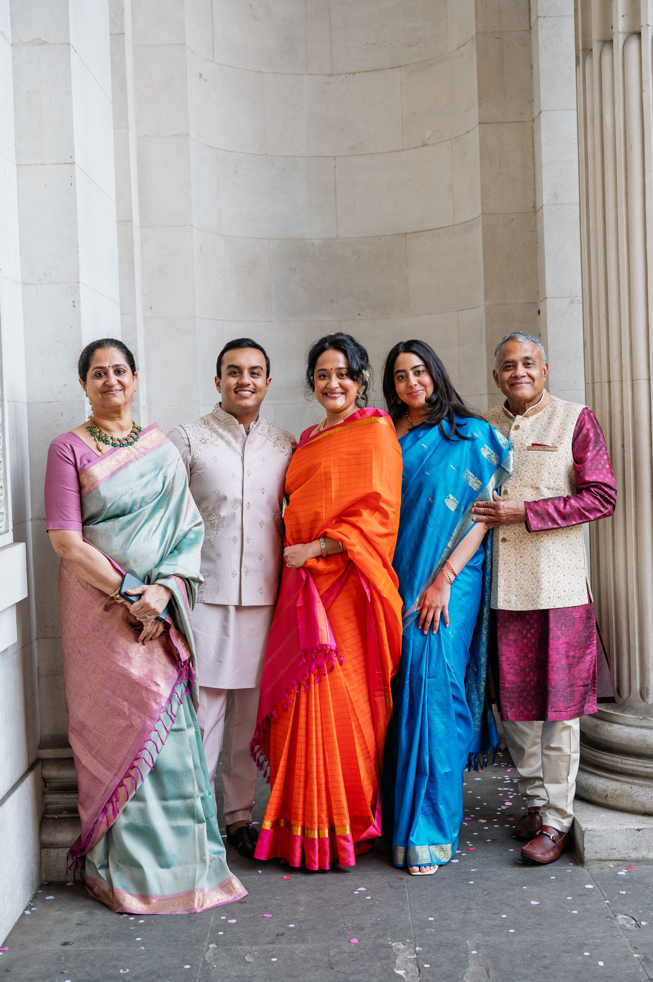 Family group in silk saris and kurtas outside Old Marylebone Town Hall