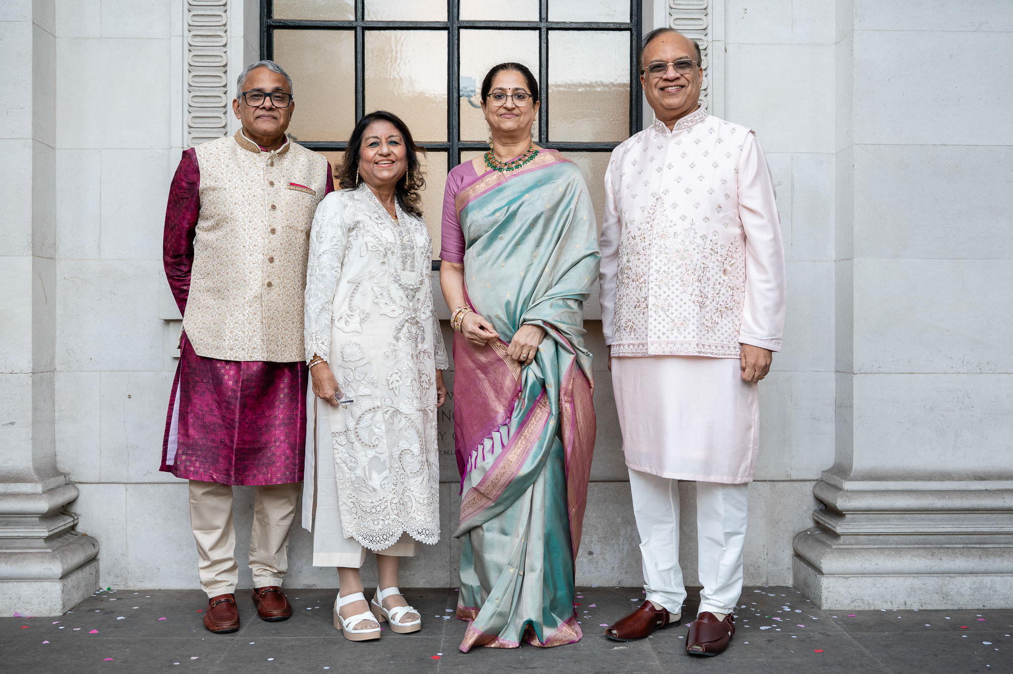 Four family members in traditional Indian dress by the columns at Old Marylebone Town Hall