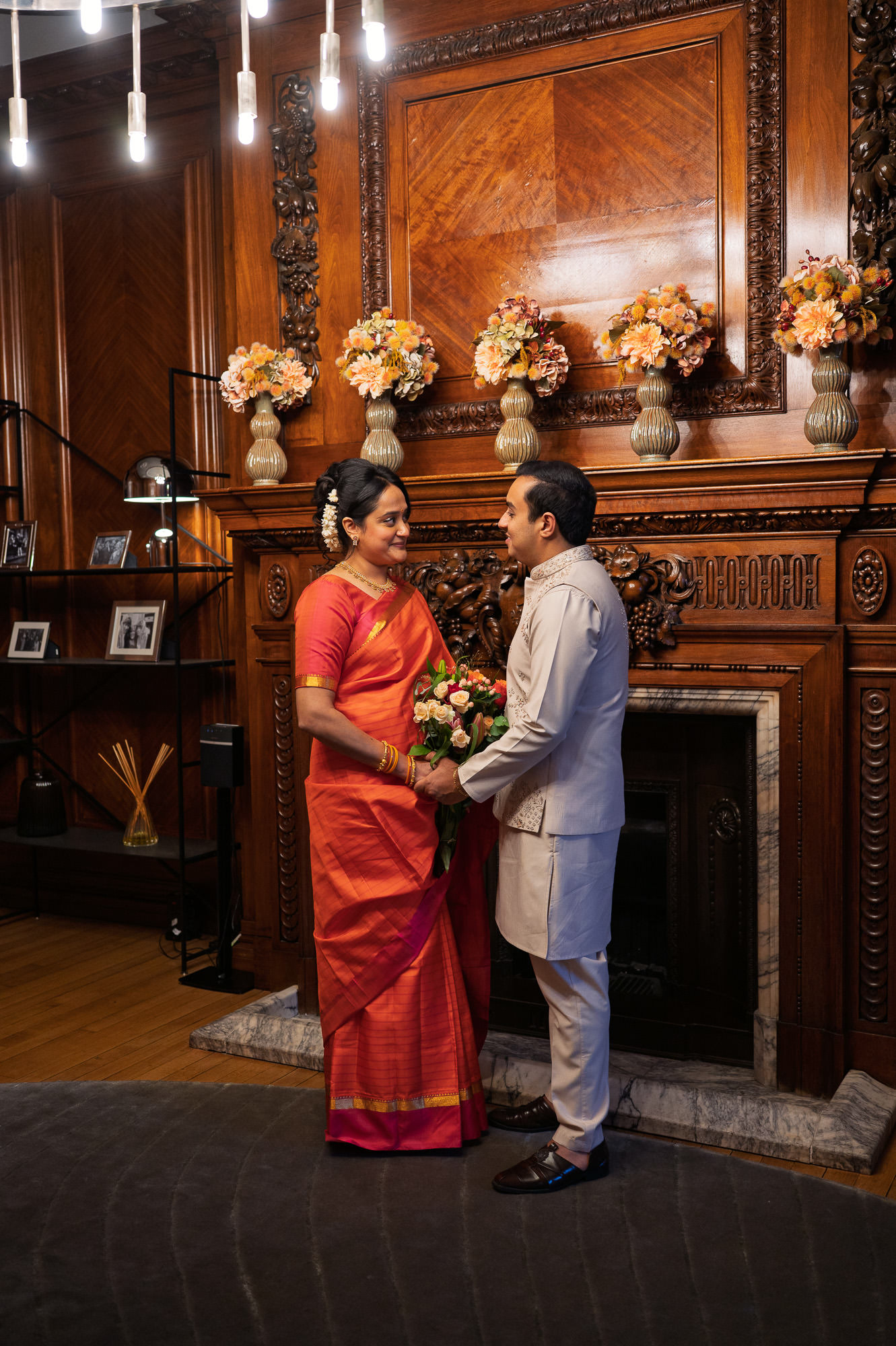 Bride and groom in front of the fireplace in the Paddington Room at Old Marylebone Town Hall