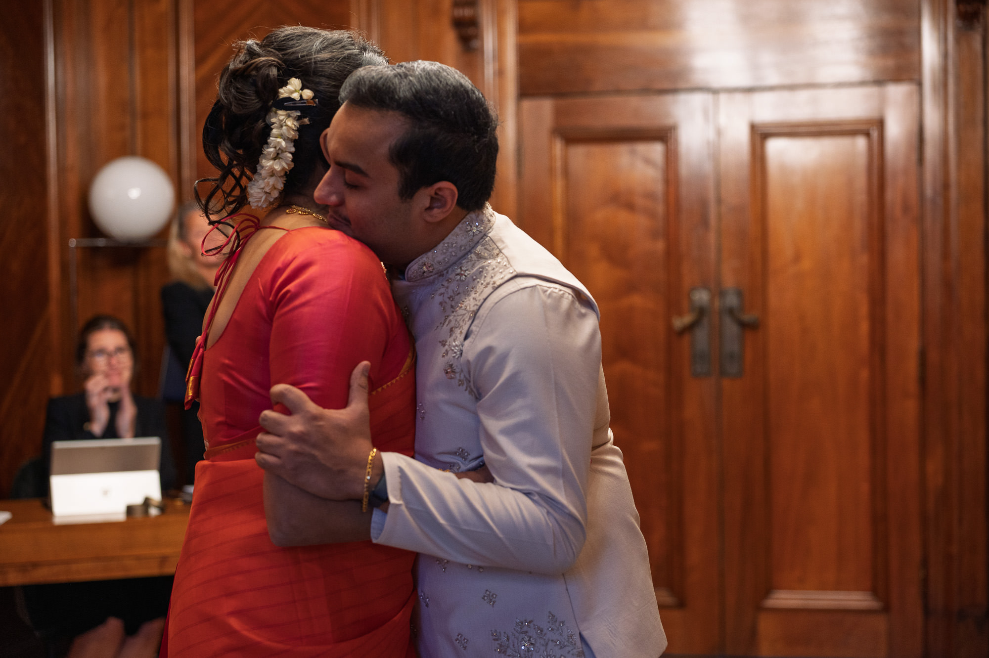 Bride and groom hugging during their ceremony in the Paddington Room