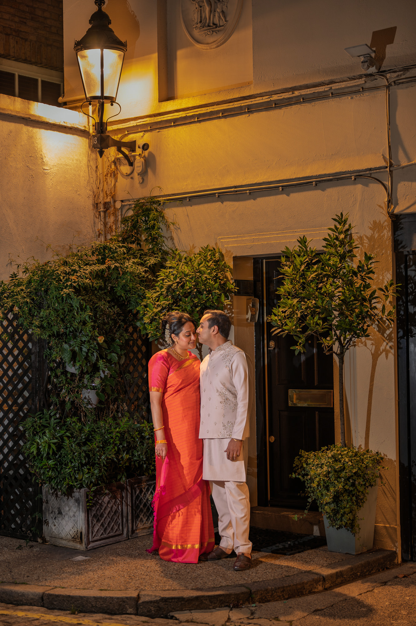 Bride and groom under a street lamp in Marylebone at night