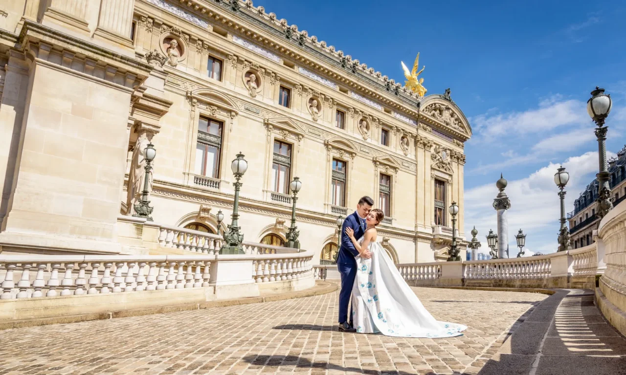 Bride in a white gown and groom outside the Palais Garnier opera house, Paris