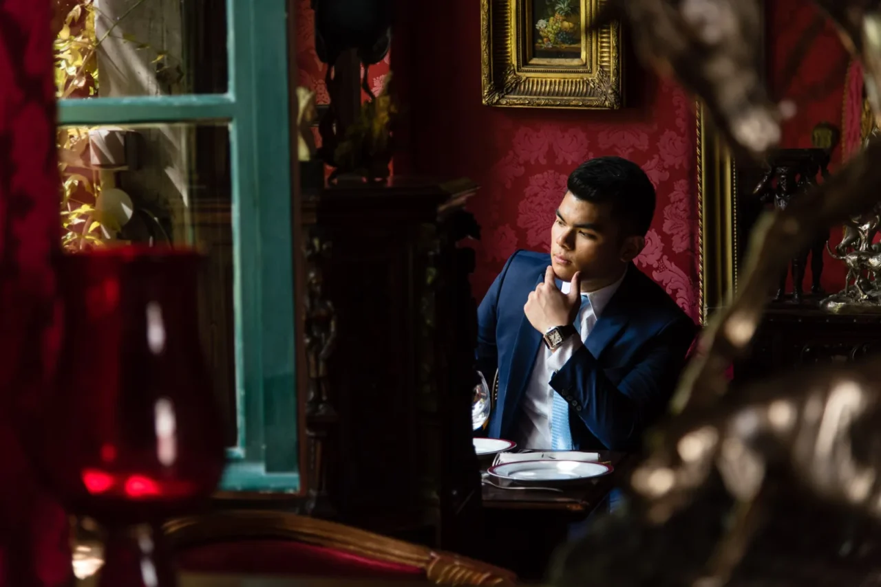 Groom portrait inside a red Parisian cafe