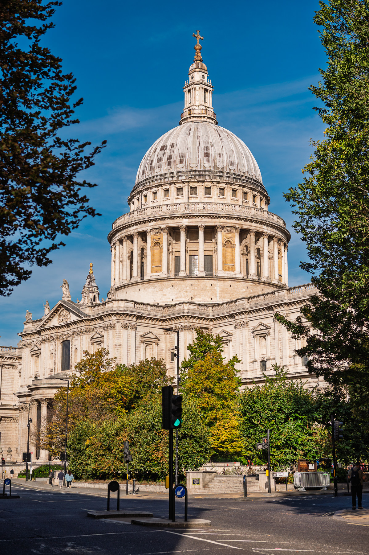 St Paul's Cathedral dome against a blue autumn sky, seen from the street