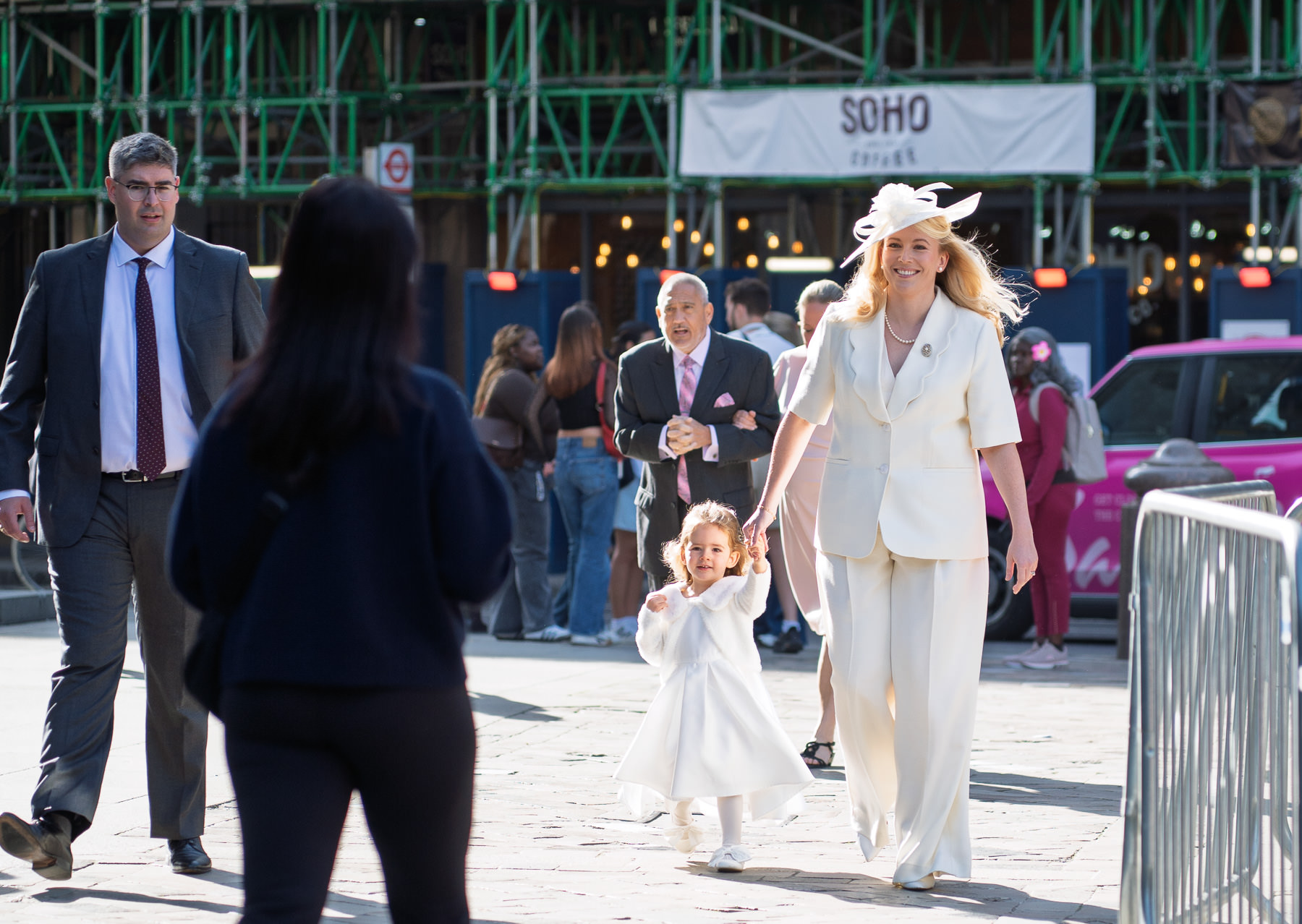 Family arriving across the piazza at St Paul's Cathedral for a christening
