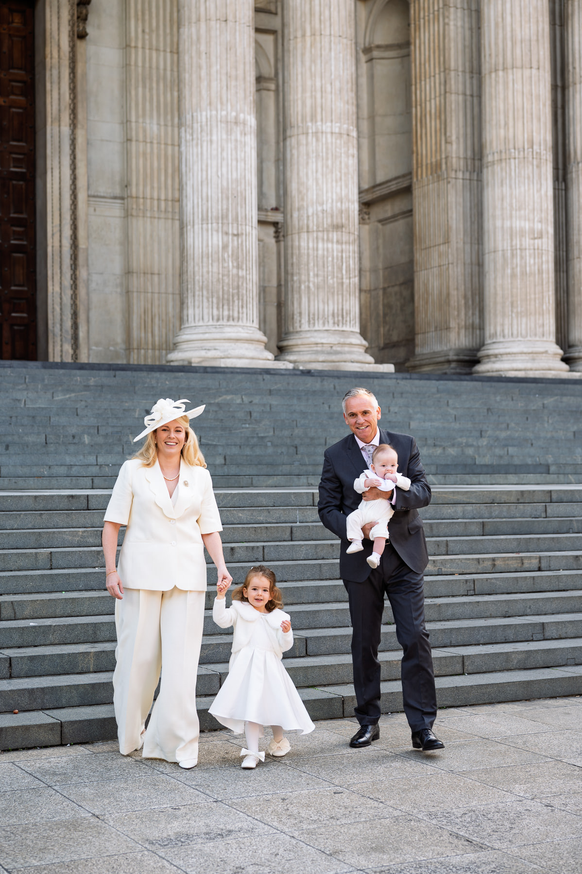 Parents with their daughter and baby on the west steps of St Paul's Cathedral before the christening