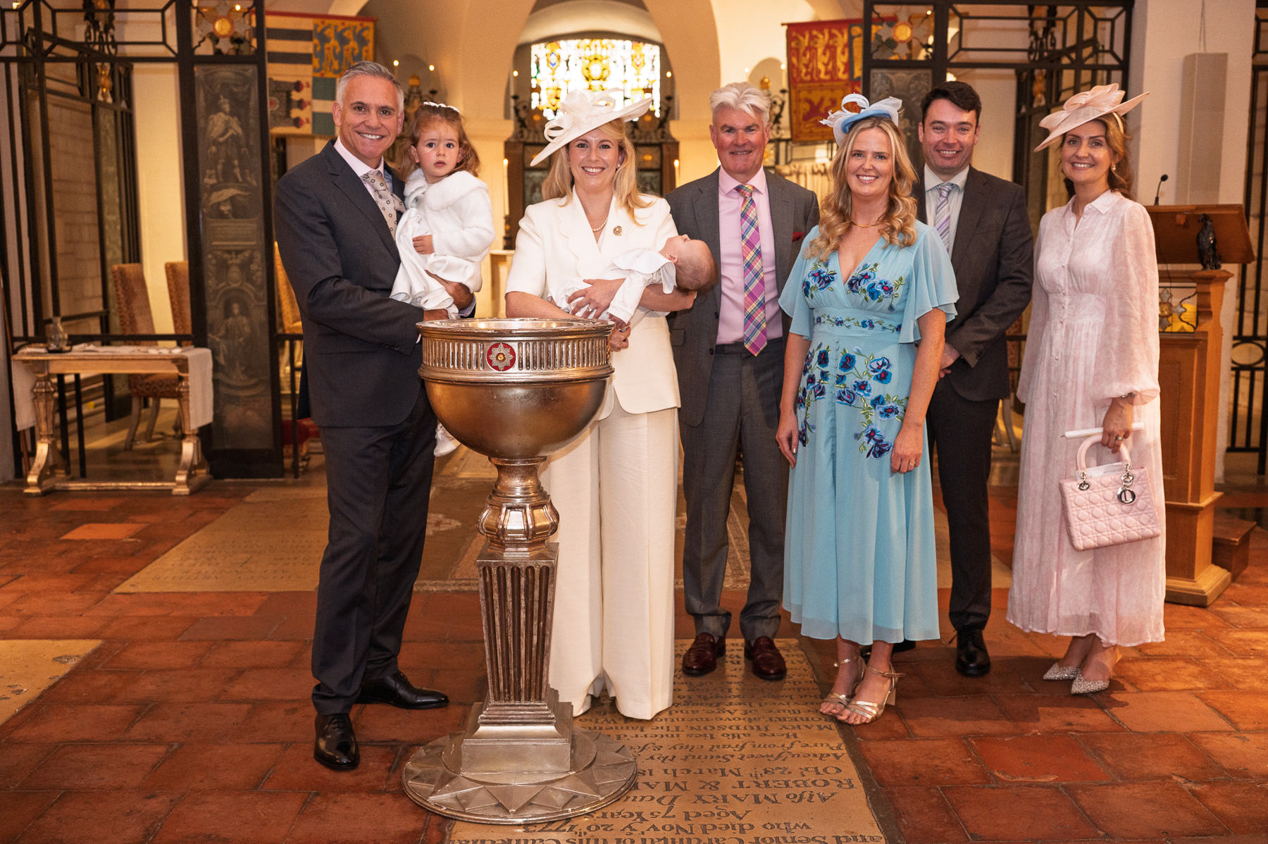 Family group around the font in the OBE Chapel at St Paul's Cathedral after the christening