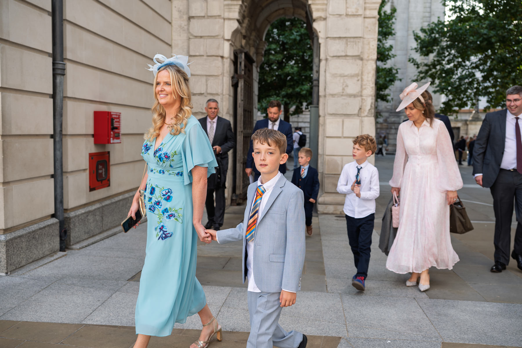 Christening guests walking from St Paul's Cathedral towards the square