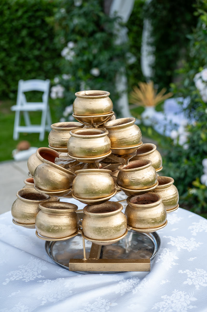 A tray of small gold pots waiting to be filled with milk during the Sri Lankan ceremony