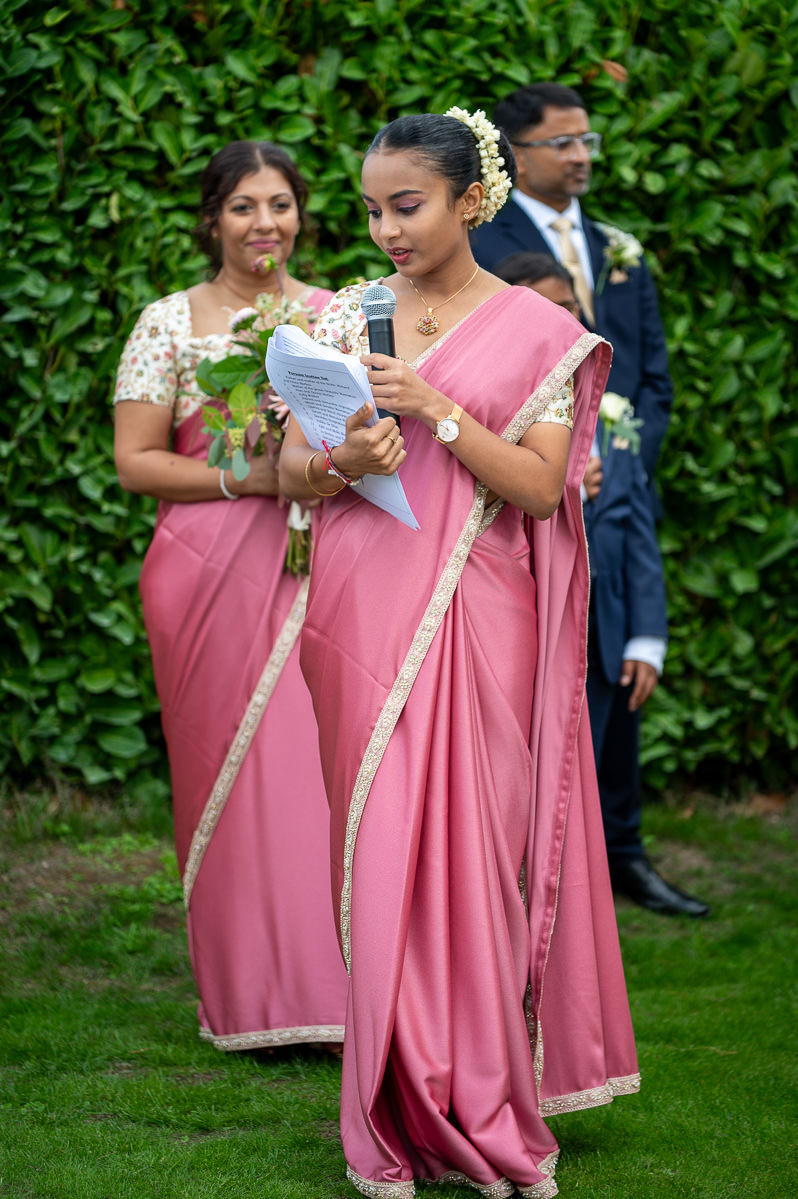 A bridesmaid giving a reading during the ceremony