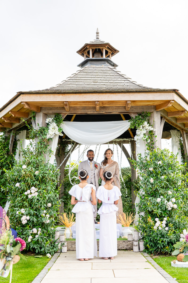 The bride and groom under the oak pergola at Selden Barns