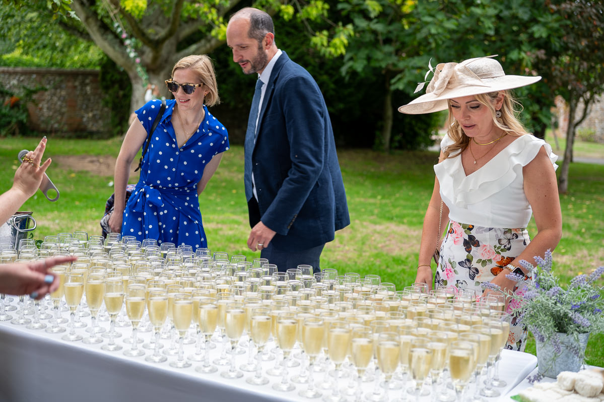 Guests helping themselves to champagne on the lawn after the ceremony