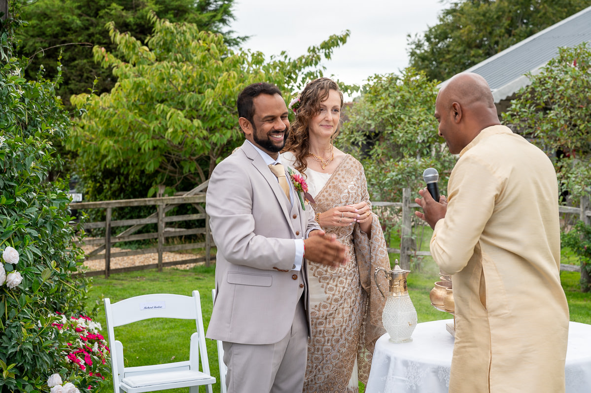 A speech during drinks, the bride and groom listening