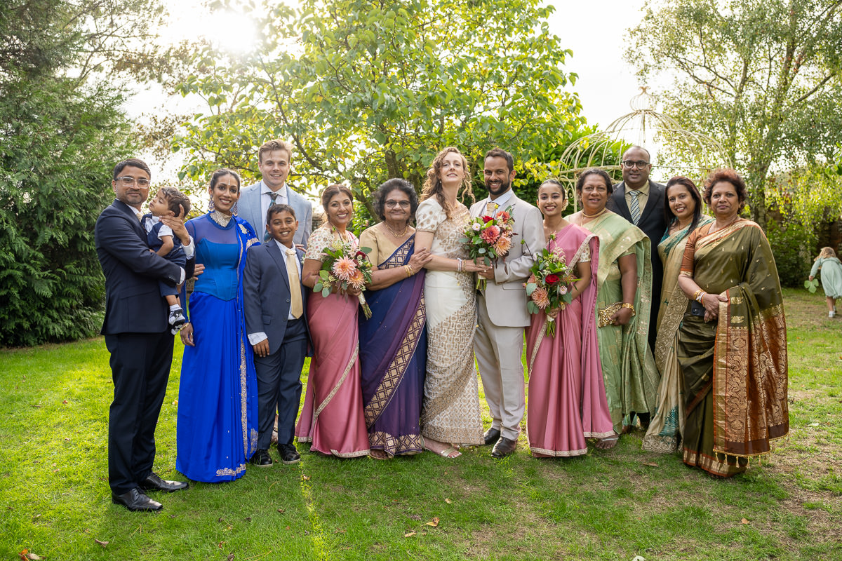 An extended family group photograph in the garden at Selden Barns