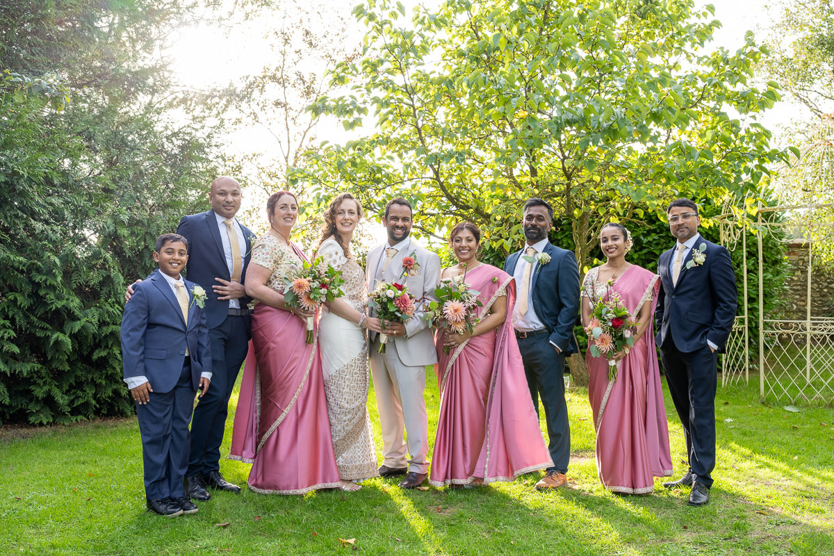 The wedding party — bridesmaids in pink sarees and groomsmen — at Selden Barns