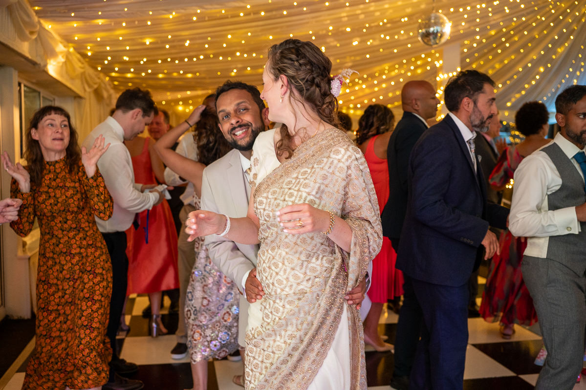 The dancefloor under fairy lights in the barn at Selden Barns