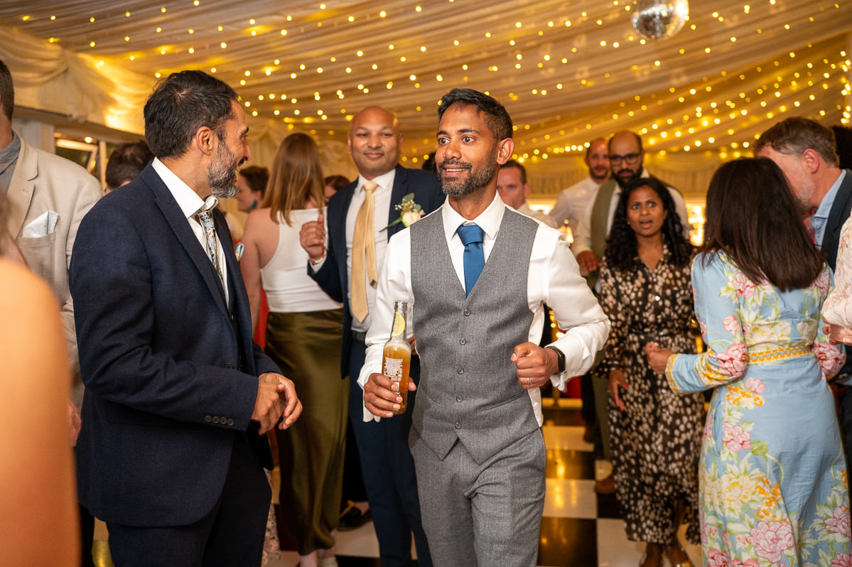 Guests on the dancefloor in the barn at Selden Barns