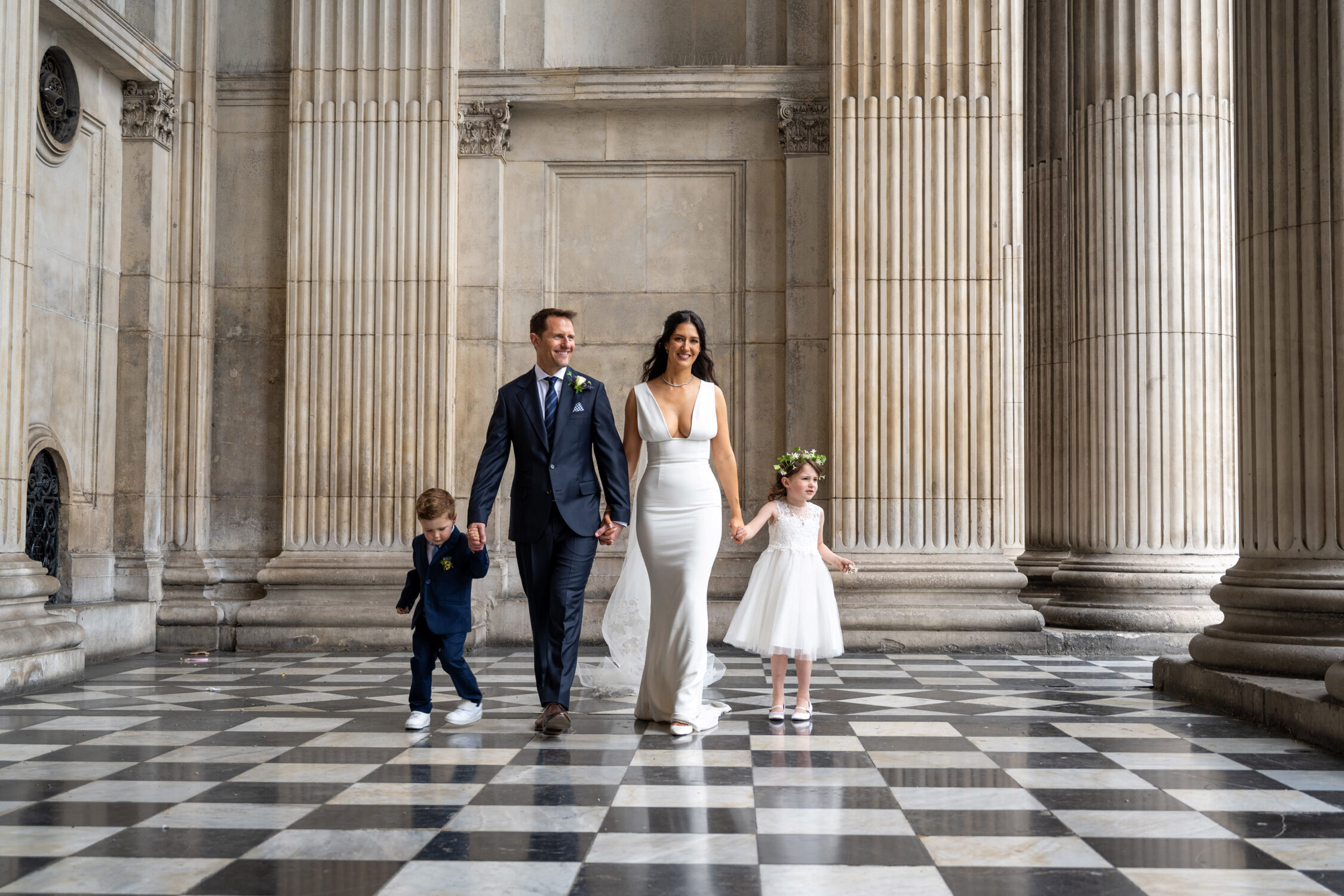 Family walking across the chequered floor inside St Paul's Cathedral