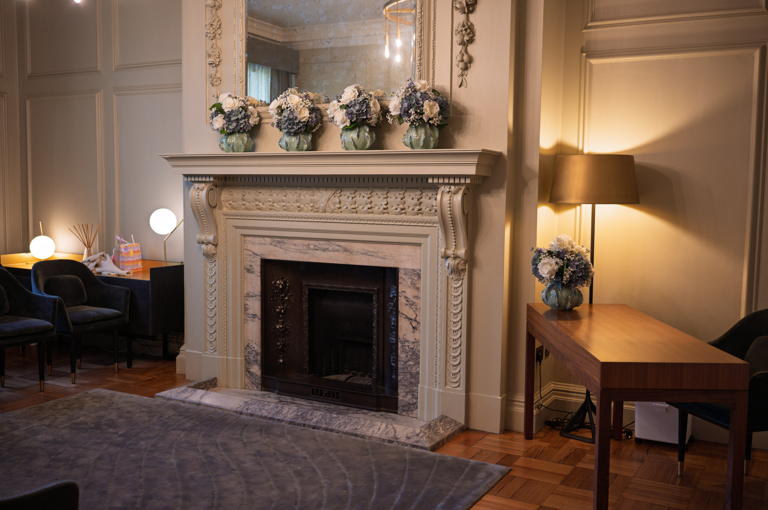 The Pimlico Room at Old Marylebone Town Hall before the ceremony, fireplace and flowers on the mantel