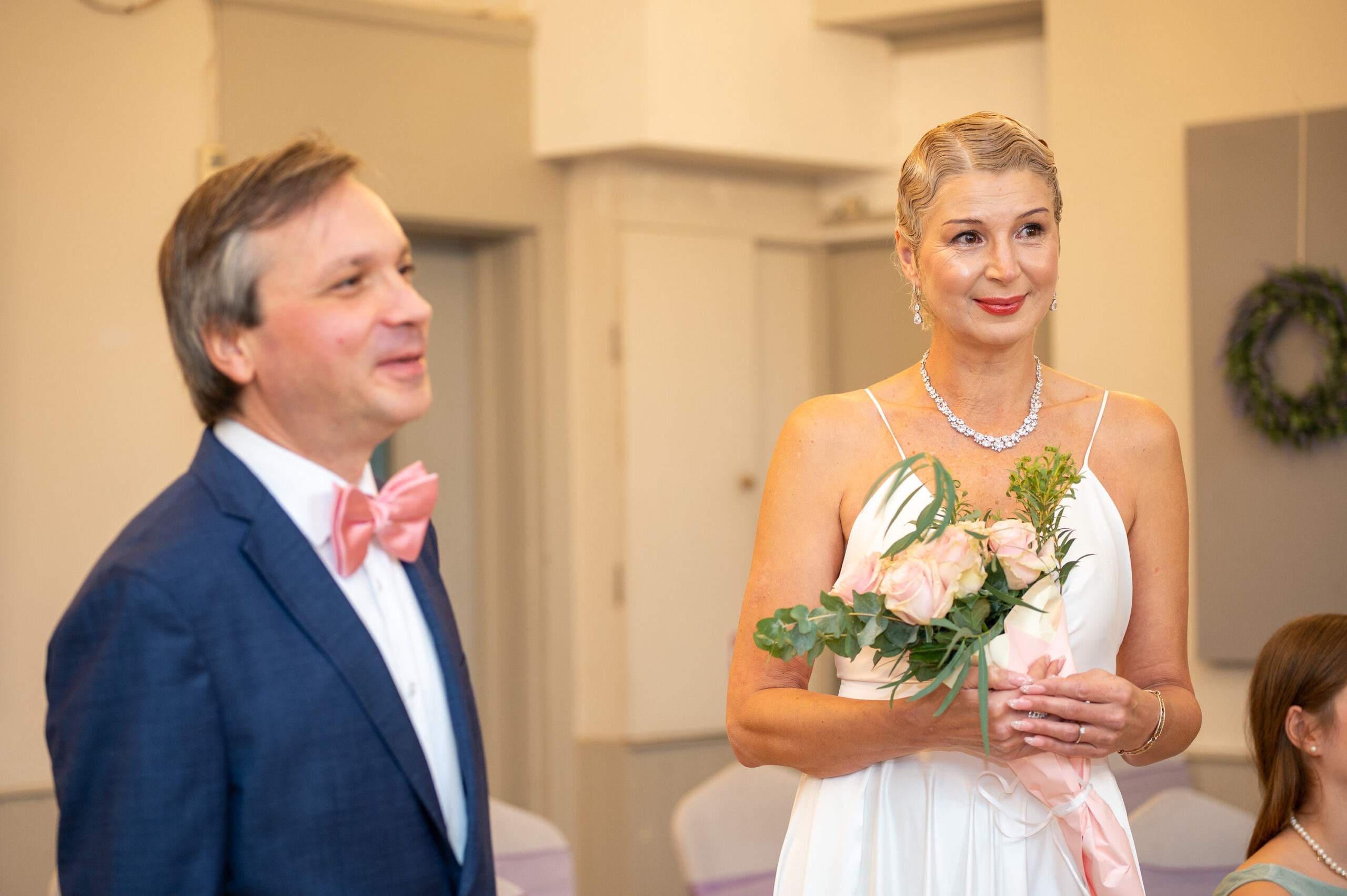 Alexei and Nataliia smiling side by side during their wedding ceremony in Ealing, London